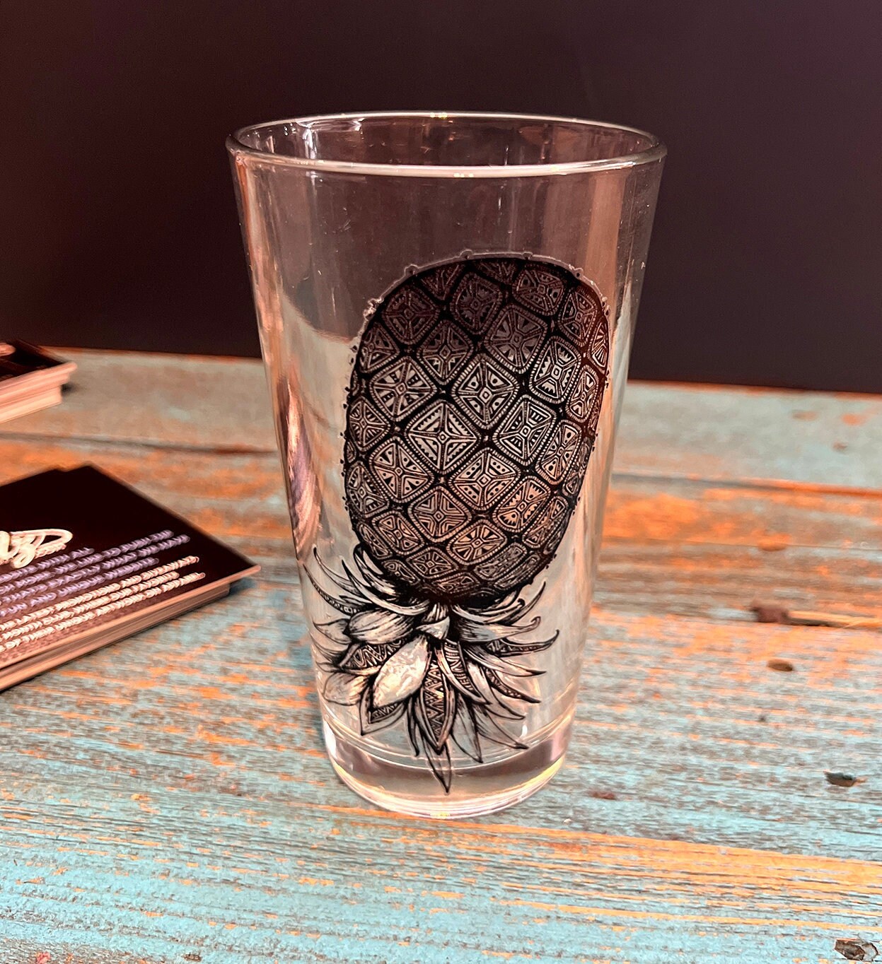 glass tumbler with upside-down pineapple